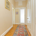 Hallway with rug, doors.