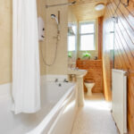 Compact bathroom, tub, sink.