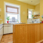 Kitchen with wood paneling.