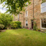 Garden, stone building facade.