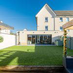 Back garden view with artificial turf and outdoor seating