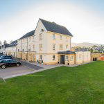 Exterior view of a residential building with parking