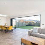 Modern open-plan living area with dining space and sliding doors