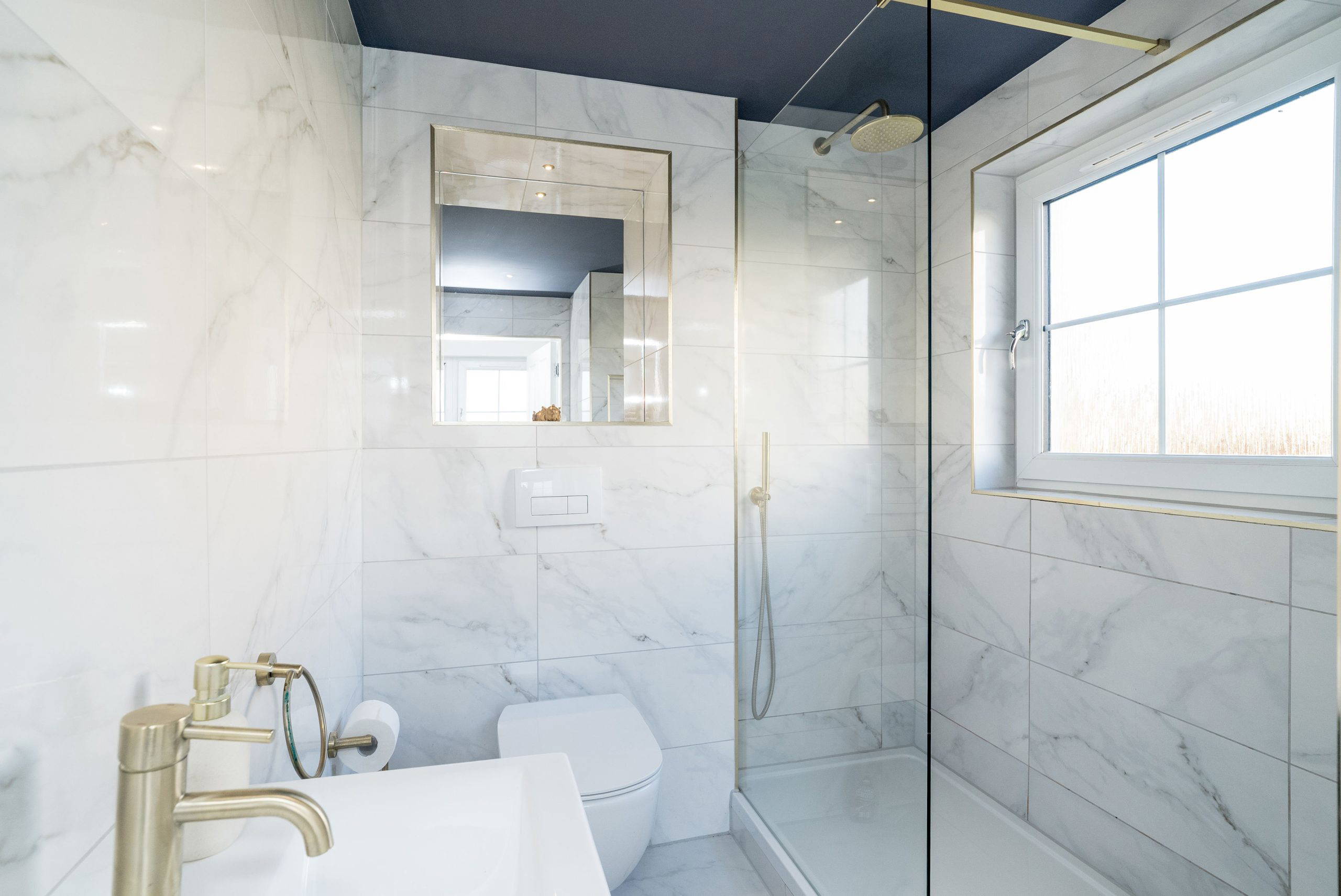 Modern shower room with marble tiles