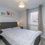 Bedroom with bed, side tables, and window