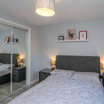 Bedroom with mirrored wardrobe