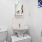 Bathroom with sink, toilet, and mirror