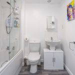 Bathroom with bathtub, toilet, and sink