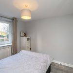 Bedroom with bed, wardrobe, and window