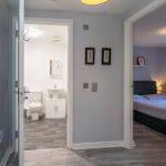 Hallway with views into bathroom and bedroom