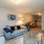 Living area with sofa, coffee table, and dining table