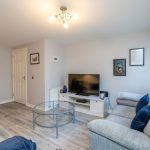 Living room with sofa, TV, and coffee table