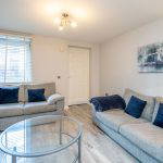 Living room with two sofas, coffee table, and wall art